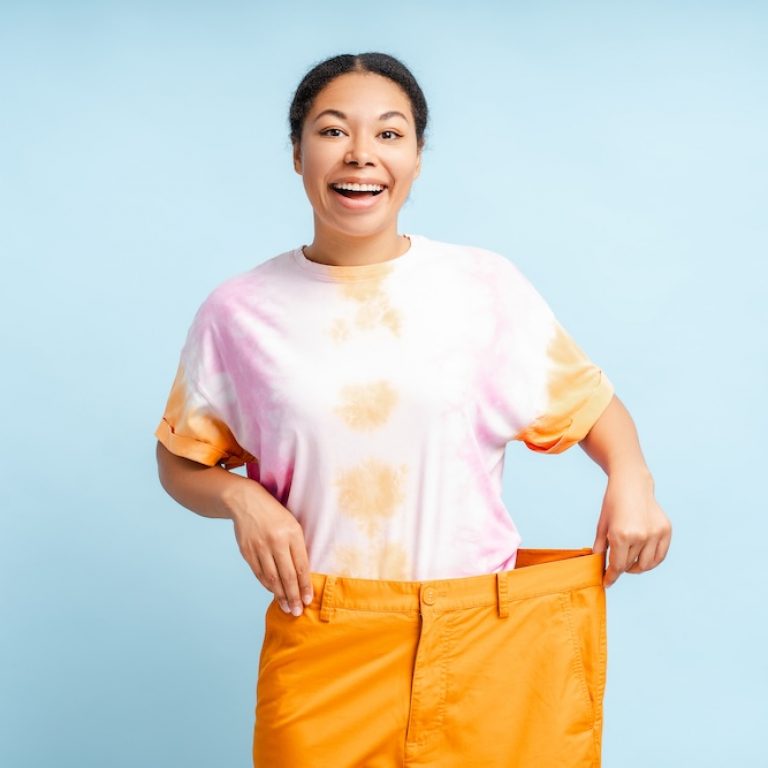 Excited woman with weight loss results from medical weight loss kansas city