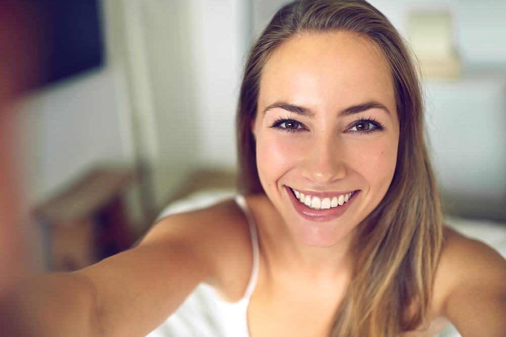 A smiling woman who is happy with her dermal filler treatment