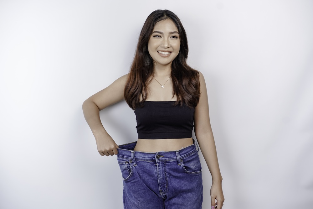 Woman happy with the results of her weight loss programs