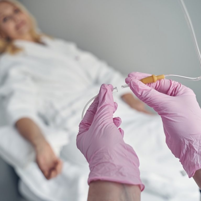 woman relaxing while she receives iv hydration